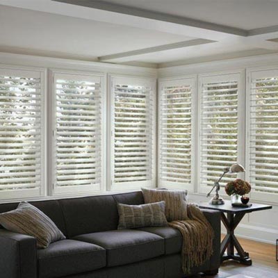 bright modern living room with dark brown furniture with white horizontal shutters