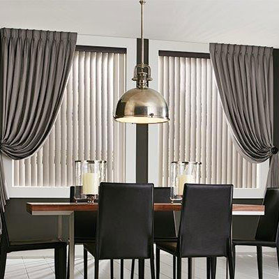 Elegant modern dining room with grey tone curtains and shades