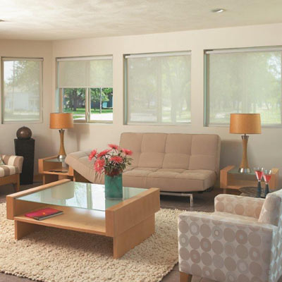 bright modern living room with light orange furniture and shades