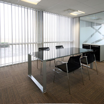 Bright conference room office space with white vertical blinds