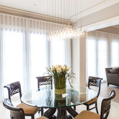 Elegant modern dining room with white blinds and flowers decoration