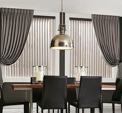 Elegant modern dining room with grey tone curtains and shades